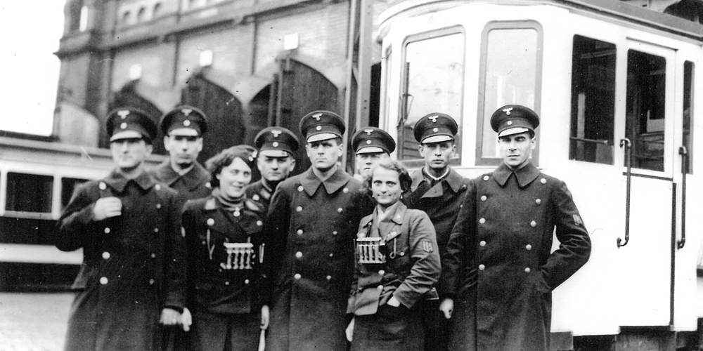 Zwei Schaffnerinnen zusammen mit ihren männlichen Kollegen im Betriebsbahnhof I in der Mannheimer Collinistraße, 1939