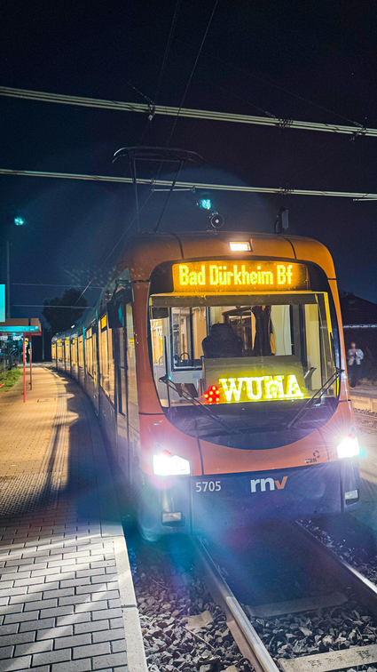 Eine Straßenbahn vom Typ RNV mit der Leuchtschrift "WUMA" im Fahrerfenster.